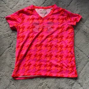 Bright pink girls Under Armour shirt from academy.